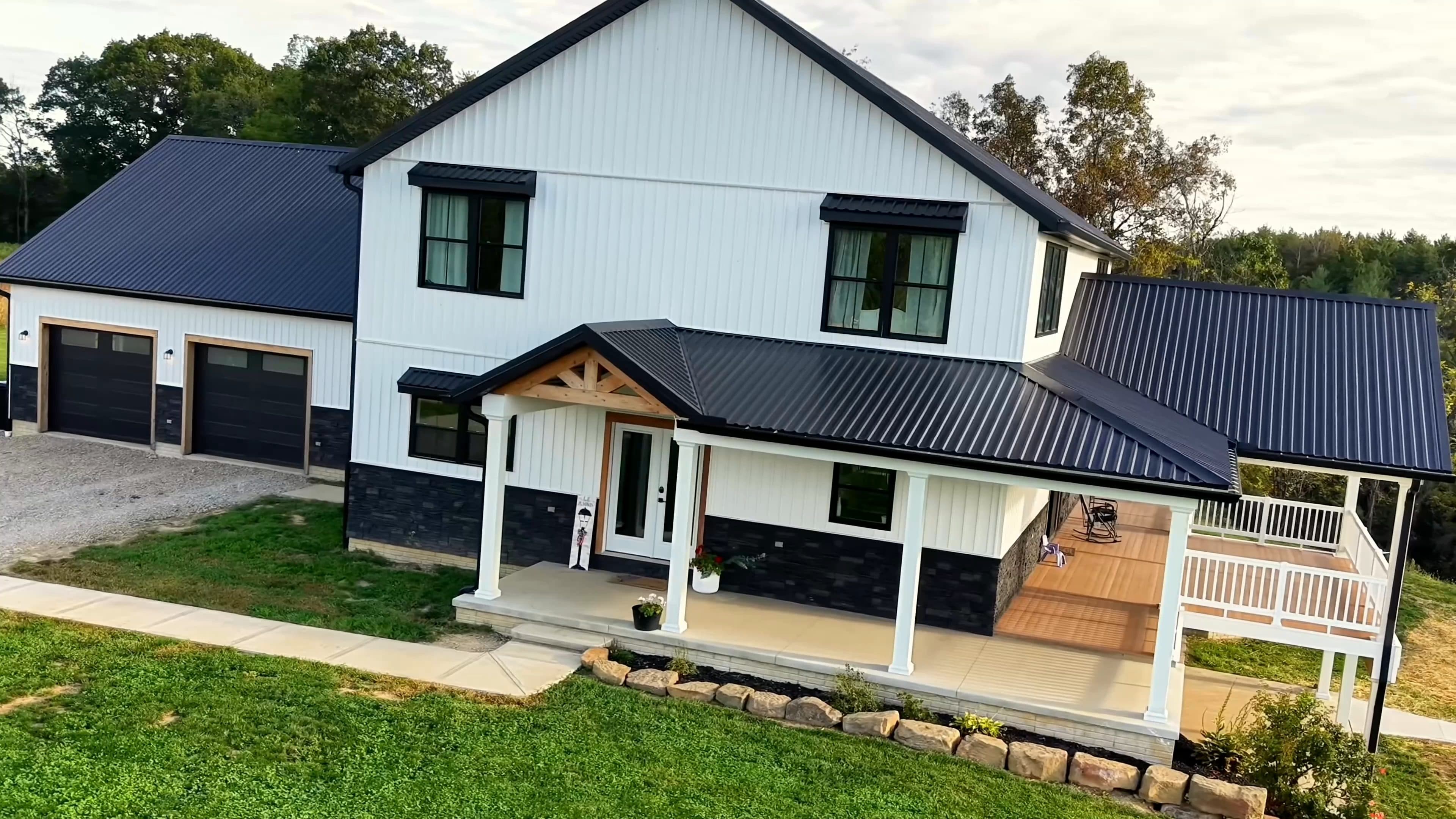 Modern farmhouse exterior with a covered porch photographed by drone, by Horizon Heights Productions.