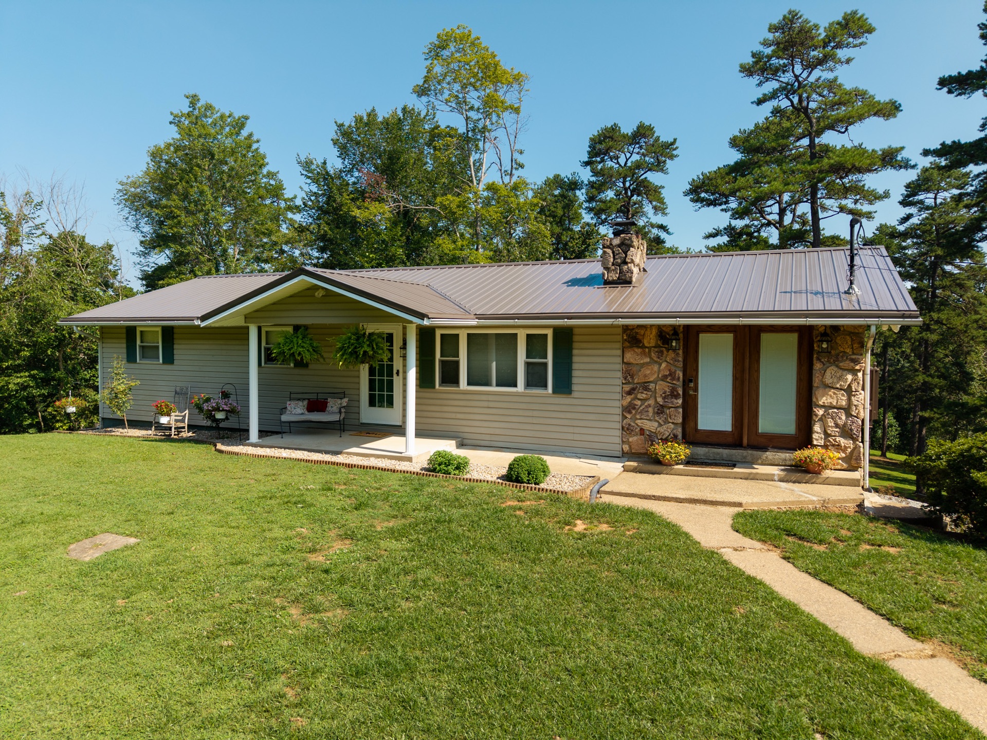 Elevated drone photograph of a luxury brick home in Marietta, Ohio with mature landscaping and circular driveway